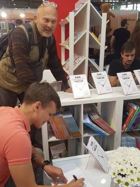 Никита Алексеев подписывает книгу на книжной ярмарке